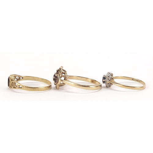 1765 - Three 9ct gold rings comprising garnet cluster, solitaire sapphire and black onyx love heart, sizes ... 