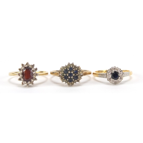 1704 - Three gold rings comprising 18ct gold garnet and diamond, 18ct gold sapphire solitaire and 9ct gold ... 