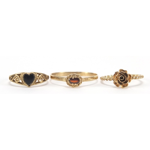 1745 - Three 9ct gold rings including black onyx love heart and garnet, sizes J, M and U, 3.8g