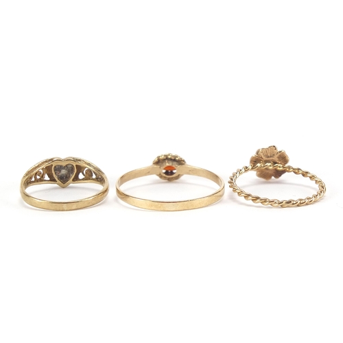 1745 - Three 9ct gold rings including black onyx love heart and garnet, sizes J, M and U, 3.8g