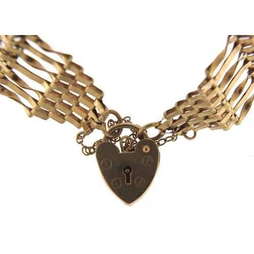 1734 - 9ct gold seven row gate link bracelet with love heart padlock, 18cm in length, 8.2g