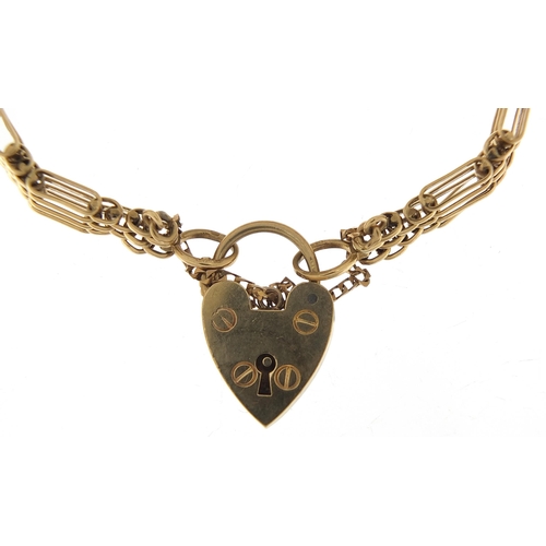 1685 - 9ct gold graduated nine row gate link bracelet with love heart padlock, 18cm in length, 23.6g