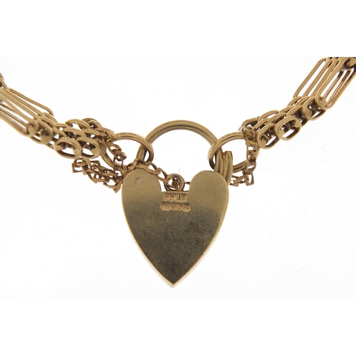 1685 - 9ct gold graduated nine row gate link bracelet with love heart padlock, 18cm in length, 23.6g