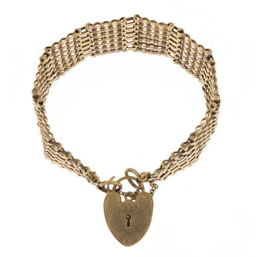 1731 - 9ct gold seven row gate link bracelet with love heart padlock, 16cm in length, 26.0g