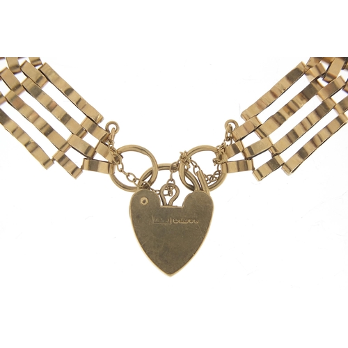 1766 - 9ct gold four row gate link bracelet with love heart padlock, 16cm in length, 10.4g