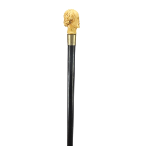 324 - Ebony walking stick with carved ivory pommel in the form of William Shakespeare, 82cm in length