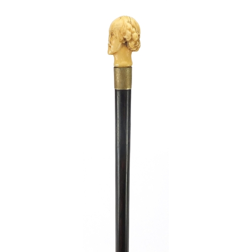 324 - Ebony walking stick with carved ivory pommel in the form of William Shakespeare, 82cm in length