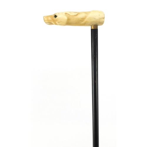 321 - Ebony walking stick with carved ivory pommel in the form of a dog's head with green glass eyes, 90cm... 