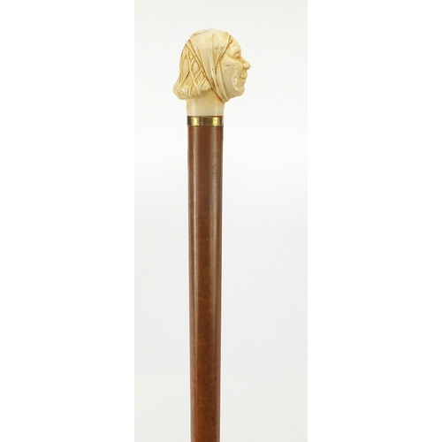 323 - Hardwood and ebony walking stick with carved ivory pommel in the form of a lady's head, 90cm in leng... 