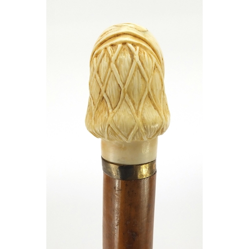 323 - Hardwood and ebony walking stick with carved ivory pommel in the form of a lady's head, 90cm in leng... 