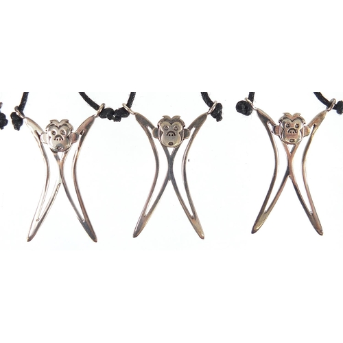 1085 - Five silver monkey pendants on necklaces