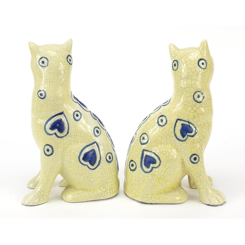 383 - Two Galle style pottery cats with glass eyes, 14cm high