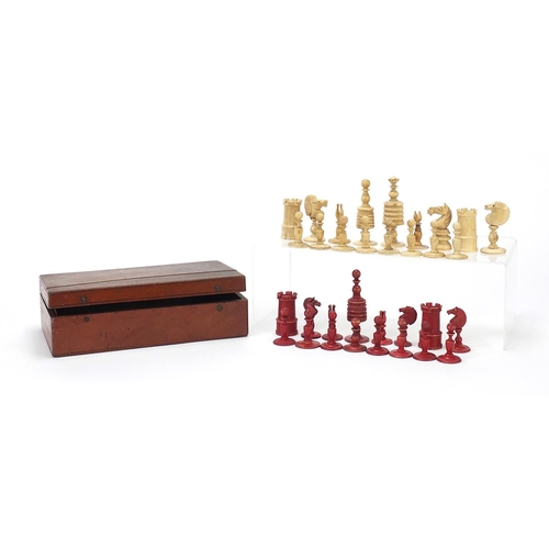 333 - Half stained carved bone chess set and a mahogany case, the largest chess pieces 8.5cm high