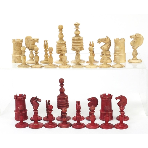 333 - Half stained carved bone chess set and a mahogany case, the largest chess pieces 8.5cm high