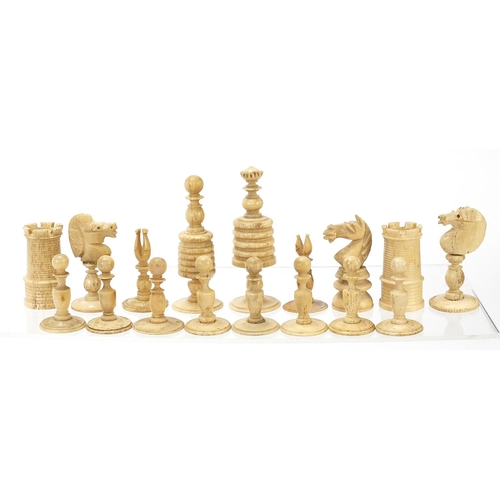 333 - Half stained carved bone chess set and a mahogany case, the largest chess pieces 8.5cm high