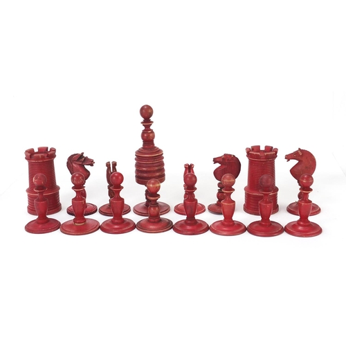 333 - Half stained carved bone chess set and a mahogany case, the largest chess pieces 8.5cm high