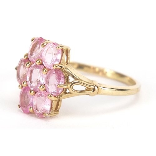 1694 - 9ct gold pink stone cluster ring with pierced shoulders, size N, 2.1g