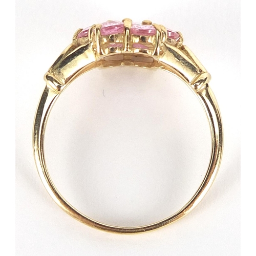 1694 - 9ct gold pink stone cluster ring with pierced shoulders, size N, 2.1g