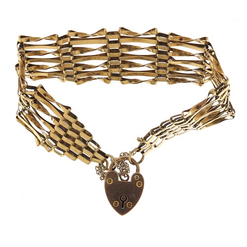 1693 - 9ct gold seven row gate link bracelet with love heart padlock, 16cm in length, 15.2g