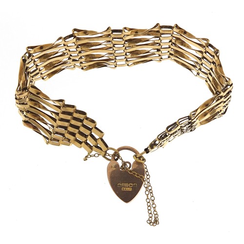 1693 - 9ct gold seven row gate link bracelet with love heart padlock, 16cm in length, 15.2g