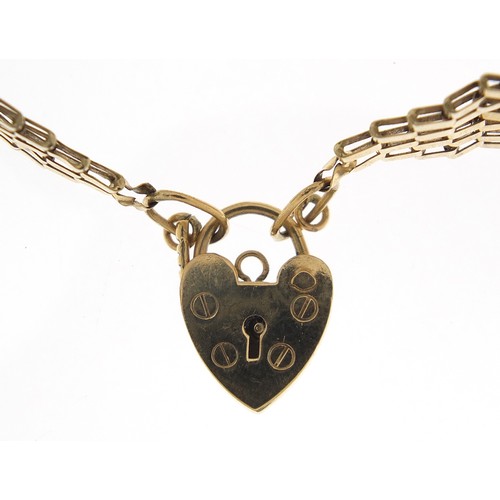 1754 - 9ct gold seven row gate link bracelet with love heart padlock, 15cm in length, 7.0g