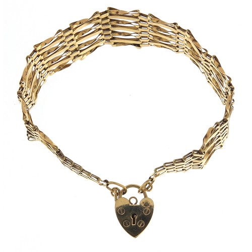 1754 - 9ct gold seven row gate link bracelet with love heart padlock, 15cm in length, 7.0g