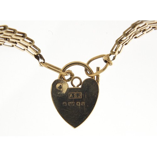 1754 - 9ct gold seven row gate link bracelet with love heart padlock, 15cm in length, 7.0g