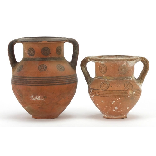 128 - Two Cypriot miniature pottery kraters with twin handles, the largest 9cm high