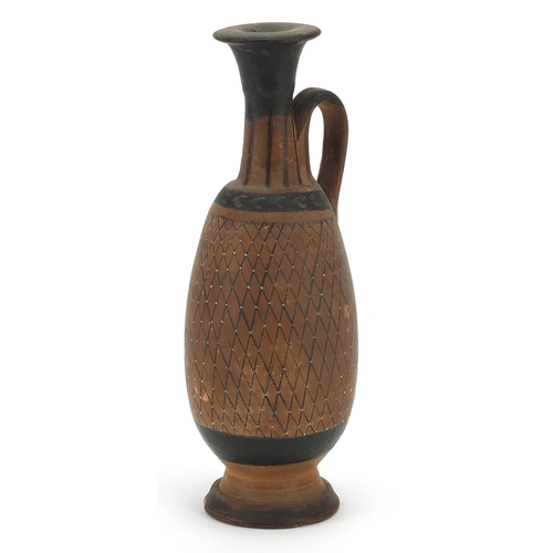 146 - South Italian pottery single handled jug hand painted with a net pattern, 17.5cm high