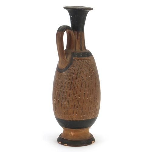 146 - South Italian pottery single handled jug hand painted with a net pattern, 17.5cm high