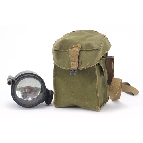 2456 - Military interest WW2 spot light with green canvas carrying bag dated 1944, the light 12.5cm high