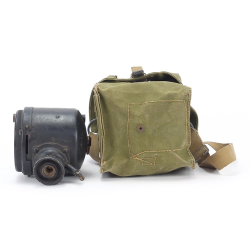 2456 - Military interest WW2 spot light with green canvas carrying bag dated 1944, the light 12.5cm high