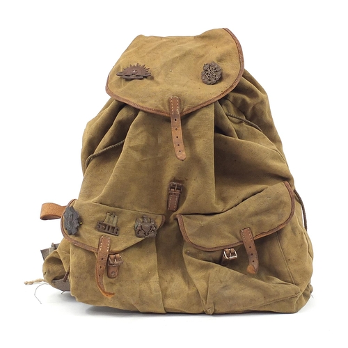 2464 - British military World War II canvas mountain backpack with cap badges including Australian Commonwe... 