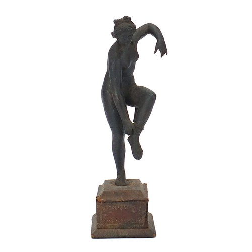 217 - Antique cast metal figure of a nude female raised on a rectangular base with tooled leather mounts, ... 