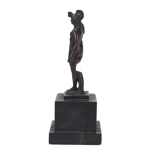 219 - Antique patinated bronze figure of a nude figure with robe, raised on a square black slate base, pos... 