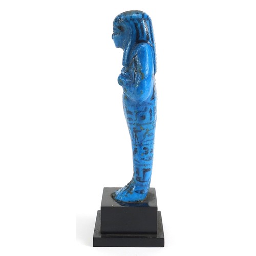 162 - Egyptian blue faience glazed stone ushabti hand painted with hieroglyphics, raised on a later ebonis... 