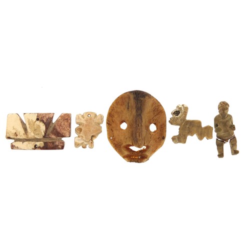 175 - Antiquities including a carved bone face mask, the largest 4cm high
