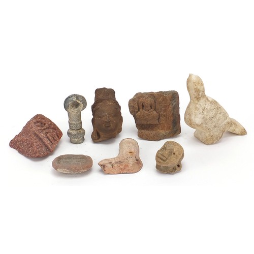 166 - Stone antiquities including a marble carving of a bird and stone fragments, the largest 13cm high