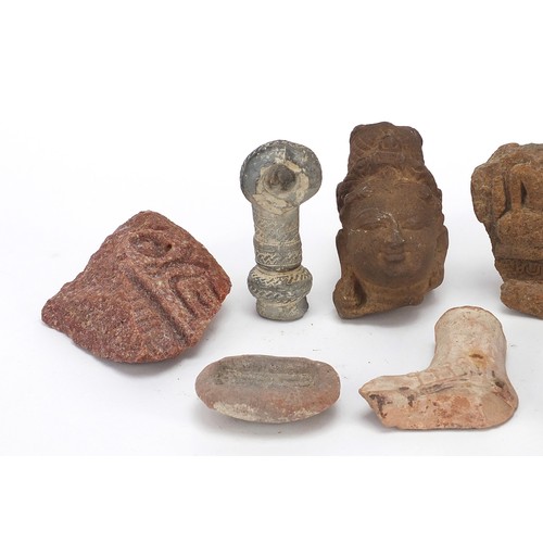 166 - Stone antiquities including a marble carving of a bird and stone fragments, the largest 13cm high
