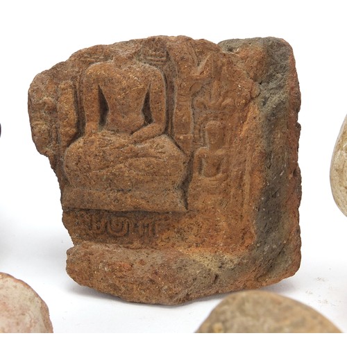 166 - Stone antiquities including a marble carving of a bird and stone fragments, the largest 13cm high