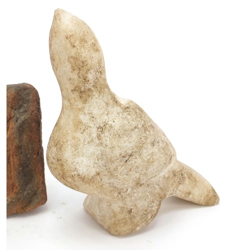 166 - Stone antiquities including a marble carving of a bird and stone fragments, the largest 13cm high