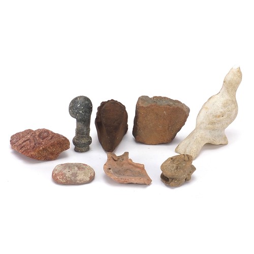 166 - Stone antiquities including a marble carving of a bird and stone fragments, the largest 13cm high