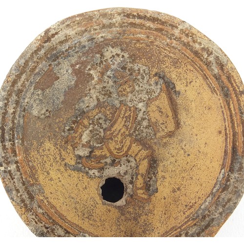 172 - Roman terracotta oil lamp decorated in relief with a figure, 9cm in length