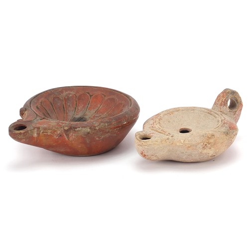 174 - Two Roman terracotta oil lamps, one with handle, the largest 12cm in length