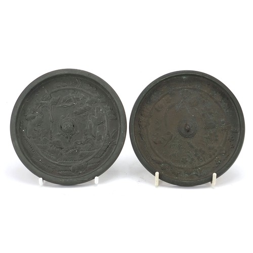 122 - Two Japanese bronzed hand mirrors cast with birds of paradise, the largest 11.5cm in diameter