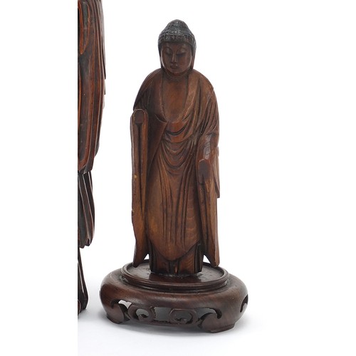 53 - Three Chinese wood carvings including one of an elder and one of standing Buddha, the largest 19.5cm... 