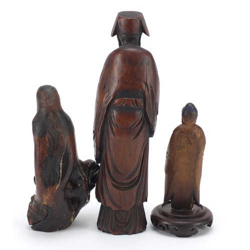 53 - Three Chinese wood carvings including one of an elder and one of standing Buddha, the largest 19.5cm... 