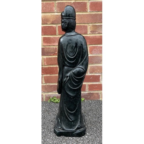 50 - Large Chinese carved green/black stone figure of a standing figure holding a scroll, 69cm high
