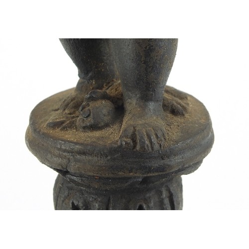 218 - Antique cast metal figure of Putti raised on a marble column base, possibly Greek or Cypriot, 30cm h... 