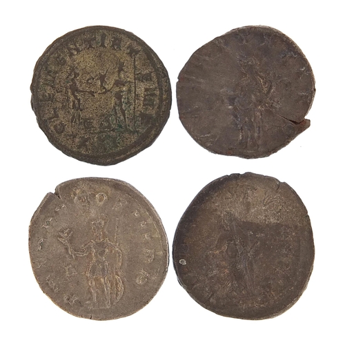 2518 - Four Roman silver and bronze coins, 14.8g, the largest 2.2cm in dimeter